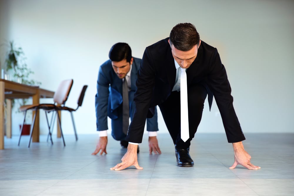 Two businessmen getting ready for corporate race - rat race concept